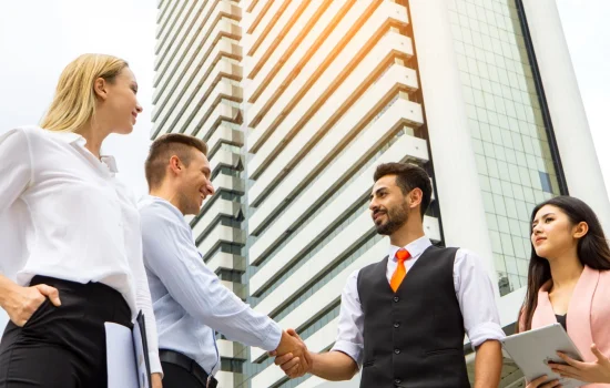 low-angle-view-business-colleagues-discussing-while-standing-city